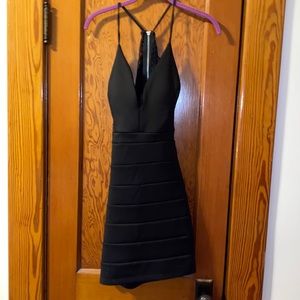 Tight mini black dress with lace back